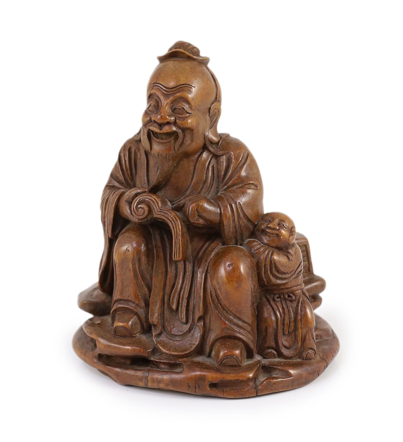 A Chinese carved bamboo figure of a seated sage reading a book, a boy beside him, probably 19th century, 15cm high